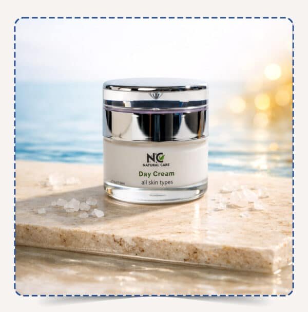 عبوة كريم النهار المرطب والمغذي Day Cream من ناتشرال كير على سطح حجري مع خلفية مائية وضوء صباحي مشرق.