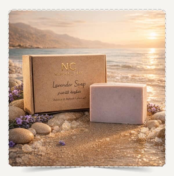 صابونة اللافندر الطبيعية Lavender Soap من Natural Care Oman على رمال الشاطئ وقت الغروب مع البحر والجبال وملح وزهور لافندر